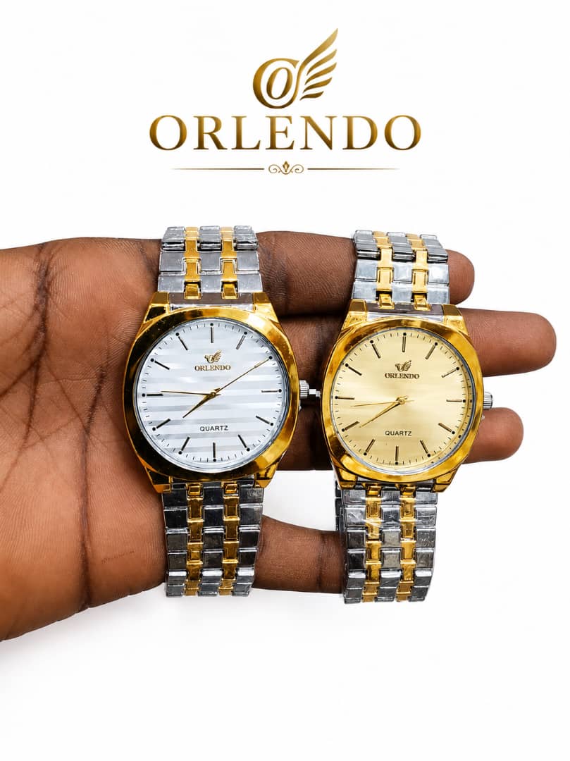 Two Orlendo men's two-tone silver and gold quartz dress watches held in hand with white and gold dials.