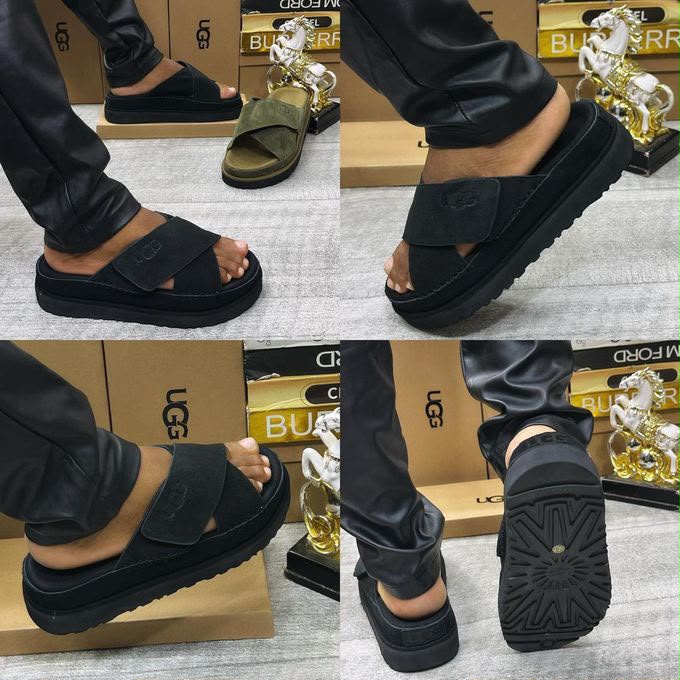 Men's UGG black suede slide sandal featuring criss-cross straps, an embossed UGG logo, and a thick platform sole.