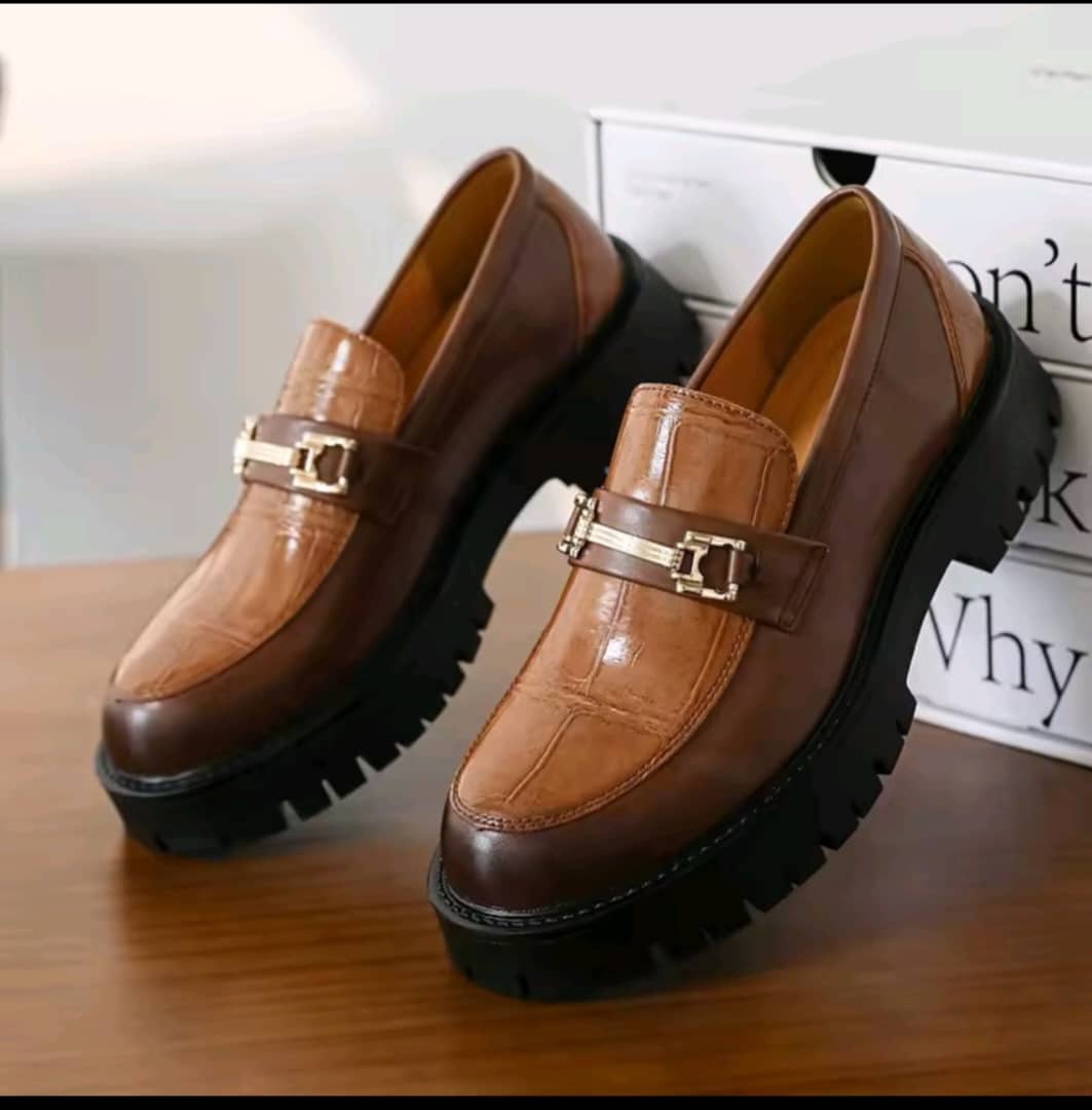 Men's brown croc-embossed platform loafer featuring a gold-tone horsebit, smooth side panels, and a chunky black lug sole.