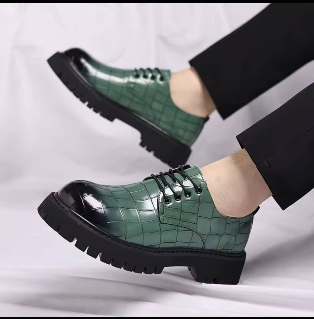 Men's forest green crocodile-embossed patent leather Derby shoes with black lug soles and black gradient toe.