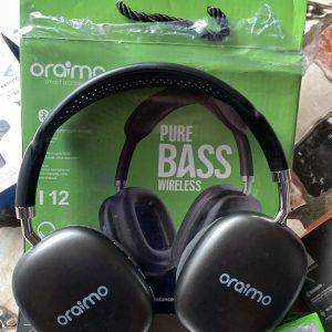 Oraimo Inspired I12 Pure Bass wireless over-ear headphones in Space Gray sitting on top of a green packaging box.