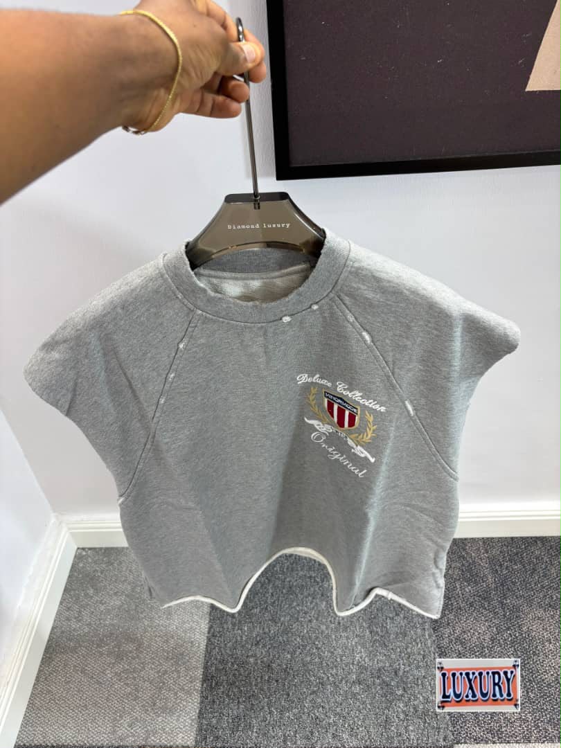 Heather gray short-sleeve sweatshirt with distressed detailing and embroidered crest logo.
